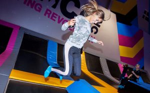 Photo of a woman smiling and jumping in Free-Jump