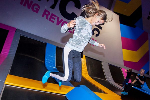 Photo of a woman smiling and jumping in Free-Jump